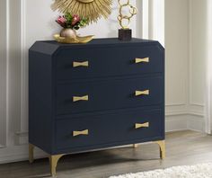 a blue dresser with gold handles and drawers