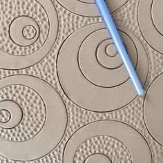 a blue toothbrush sitting on top of a white tile covered floor next to circles