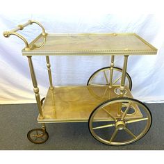 an antique brass bar cart with wheels