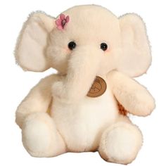 a white stuffed elephant with a pink flower on its ear