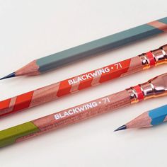 three different colored pencils sitting next to each other on a white surface with the words blackwing written on them