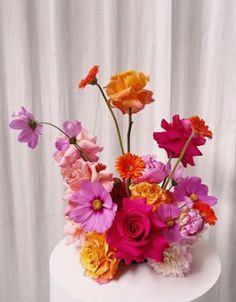 a white cake with colorful flowers on it