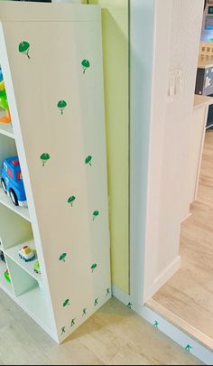 a child's playroom with toys and bookshelves in the corner on the floor