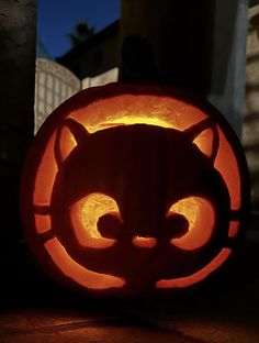 a pumpkin carved to look like a cat