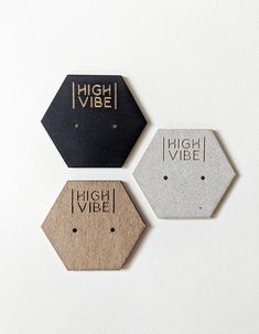 three hexagonal tags with the words high vibe on them