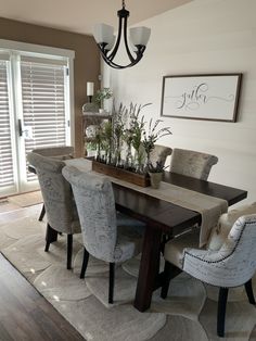 a dining room table with chairs and a chandelier