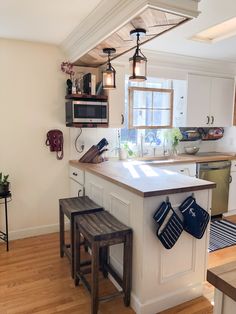 a kitchen with an island and two stools