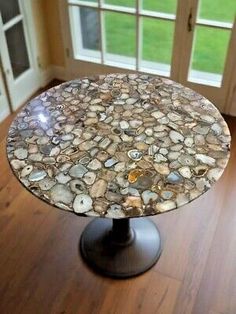 a table that is on top of a hard wood floor in front of a door