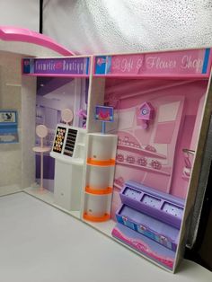 the inside of a doll house with furniture and accessories