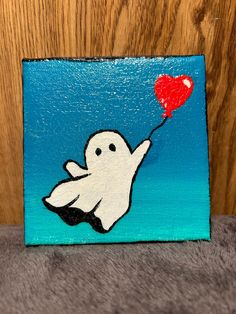 a painting of a ghost holding a red heart