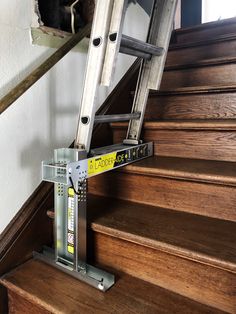 a metal hand rail on the bottom of some stairs