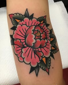 a woman's leg with a flower tattoo on it