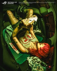 a woman laying in the back seat of a car with tattoos on her arms and legs