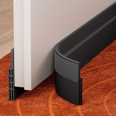 a close up of a door handle on the floor next to a wall with an orange rug