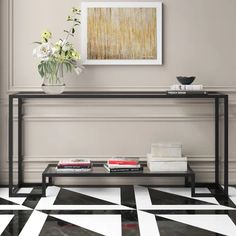 a black and white tiled floor with a vase on the end table next to it