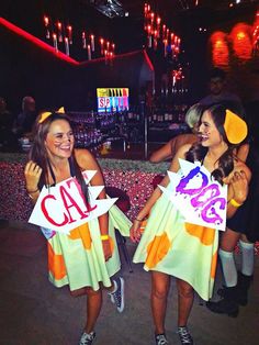 two girls in costumes holding up signs that say cat and dog halloween costumes are on instagram