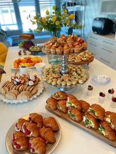 a table topped with lots of pastries and desserts on top of plates next to each other