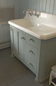 a white sink sitting under a bathroom mirror