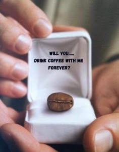 someone is holding a small box with a coffee bean in it that says, will you drink coffee with me forever?