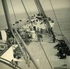 black and white photograph of people on the deck of a ship