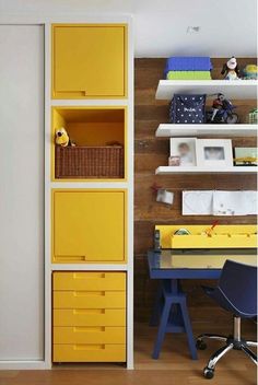 an image of a yellow bookcase with drawers