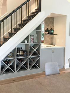 the wine rack under the stairs is full of bottles