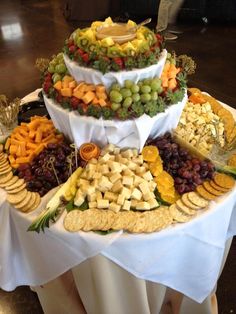 a large platter filled with different types of cheeses and crackers