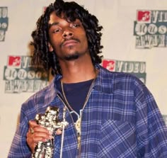 a man with dreadlocks holding an award