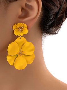 a close up of a person wearing earrings with flowers on it's earring