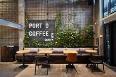 a coffee shop with tables and couches in front of a sign that says port o'coffee