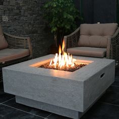 an outdoor fire pit sitting on top of a patio