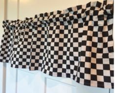 a black and white checkered curtain hanging on a wall