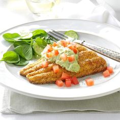 a white plate topped with meat and vegetables