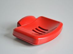 a red telephone sitting on top of a white table