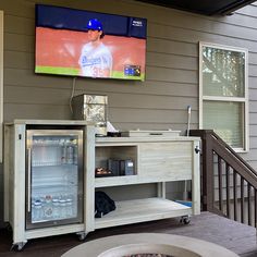 a television mounted to the side of a house