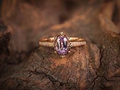 a close up of a ring on top of a piece of wood with an amethorate