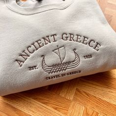 Vintage Greece City Embroidery Sweatshirt, Ancient Greece England Sweatshirt, Greece City Jumper, Vintage Greece Crewneck, Perfect Cosy Jumper for her, Vintage Crewneck Location, Location City Sweatshirt, Vintage City Embroidered Sweater I've included images showing the design on a Beige Sweatshirt, please message me for specific sweatshirt colour requests/a request for changing the embroidery colour. Check out our Shop filled with so many Designs! https://www.etsy.com/uk/shop/TahikoStitch ⬅️⬅️⬅ Blank Hoodies, Comfy Sweatshirts, Beige Sweatshirt, Oversize Sweatshirt, Vintage City, Cosy Jumper, Sailor Style, Crewneck Vintage, Vintage Hoodie