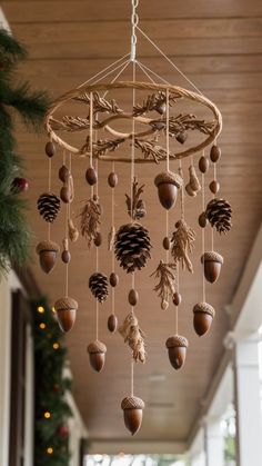 pine cones and acorns are hanging from a chandelier in the hallway