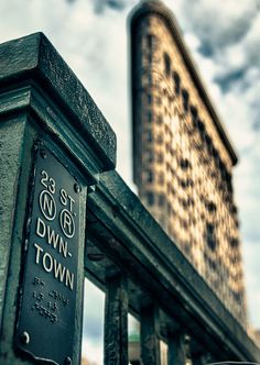 a close up of a street sign with a building in the background