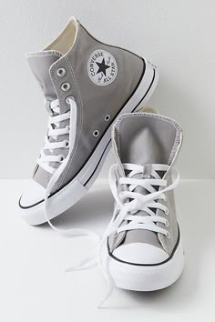 **Fit:** This style is in unisex sizing so a men's size 4 is a women’s size 6. Classic canvas high top Chuck Taylors. | Chuck Taylor All Star Hi Top Converse Sneakers at Free People in Grey, Size: US 5 M Cute Shoes Sneakers Converse, Cute Converse Shoes High Tops, Shoes For Back To School 2024, Dresses With Converse High Tops, Cute Shoes Converse, Shoes For Back To School, Converse Colors, Best Sneakers For Women