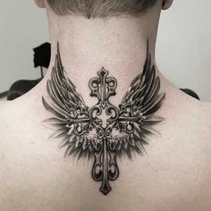 a man with a cross and wings tattoo on his back neck is looking at the camera