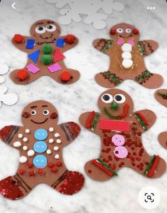 gingerbread cutouts are displayed on a marble surface