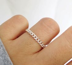 Bold and beautiful. This flexible curb chain ring is handcrafted with high-quality sterling silver material and made to order just for you. Can be worn when washing hands or showering! Wear this chain ring alone or stack it with other rings for a layered looked! Great for gifting. Handmade in Los Angeles, CA! Packaging:  Comes in a gift box, ready for gift-giving! Dimensions: Width: 3mm  Thickness: 0.6mm Material: Sterling Silver / 925 Benefits of Sterling Silver / 925 Jewelry: 1. It's hypoaller Sterling Silver Chain Ring Perfect For Gifts, Silver Link Chain Ring As Gift, Silver Chain Link Rings Gift, Minimalist Sterling Silver Rings With Chain Detail, Silver Chain Link Ring For Everyday, Silver Rings With Adjustable Chain For Everyday, Everyday Silver Chain Link Ring, Everyday Silver Rings With Chain Detail, Everyday Silver Chain Rings