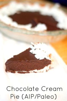 chocolate cream pie with whipped cream on top and in the background, sitting on a white napkin