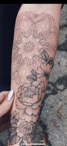 a woman's arm with flowers on it