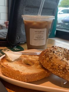 two bagels on a plate with a cup of coffee