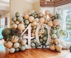 a large number made out of balloons in the middle of a room with wood flooring