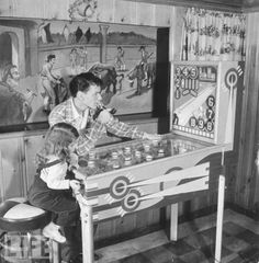 an old black and white photo of two people playing a game