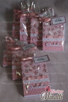 small pink gift bags with ribbons and tags