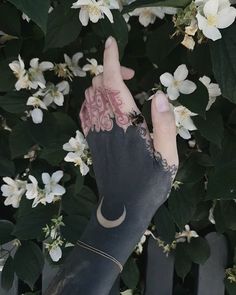 a person's arm with tattoos on it and flowers in the backgroud